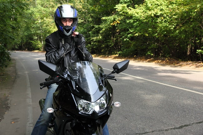 motorcycle rider straddling bike