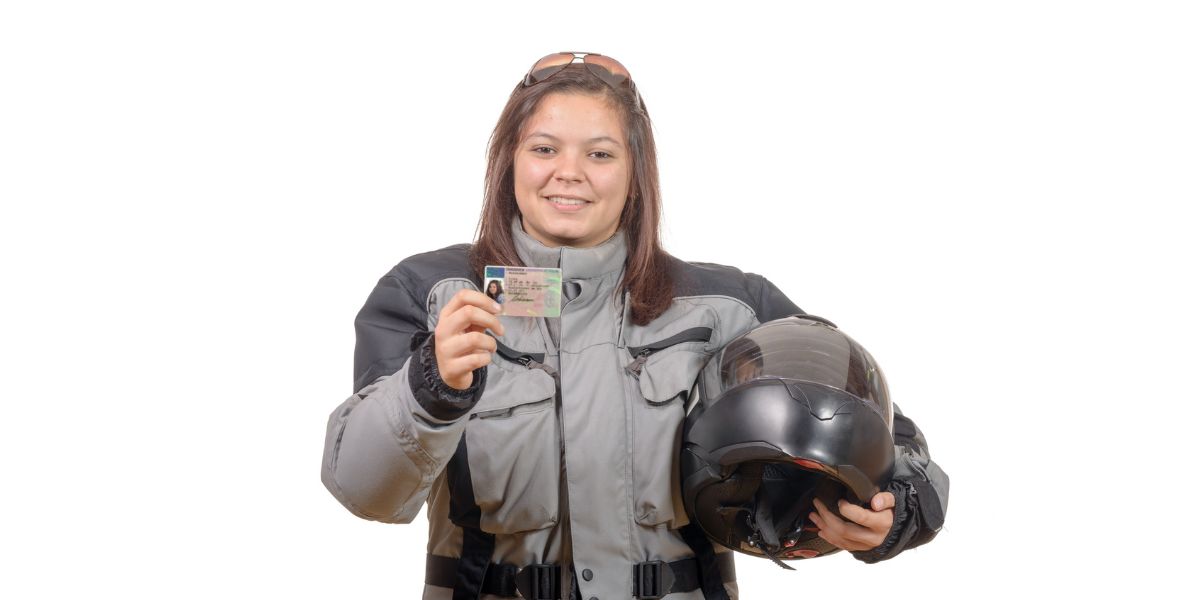 Happy young woman showing proudly her new motorcycle license — Photo