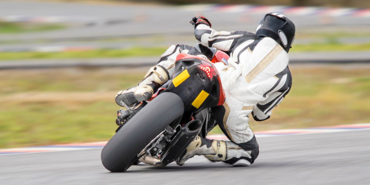 Motorcycle leaning into a fast corner on track