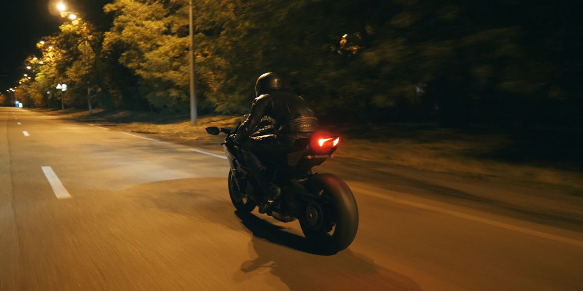 Motorcyclist racing his motorcycle on evening city.